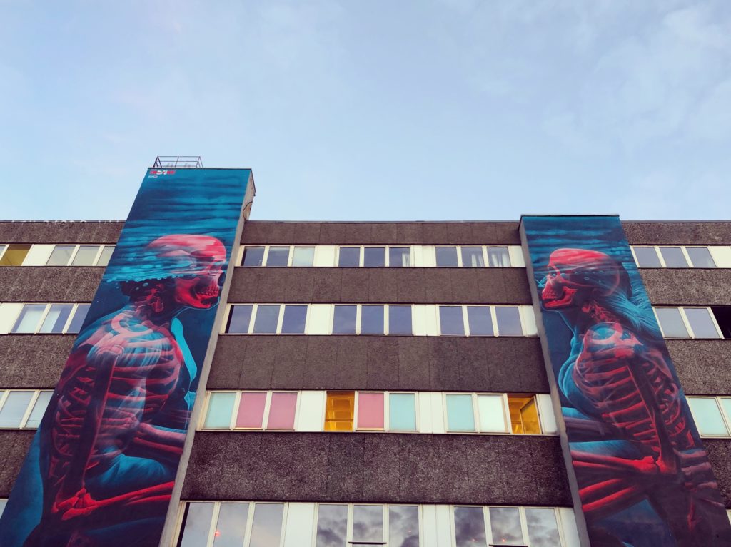 3D male/female skeletons graffiti over a building facate in Kreuzberg, Berlin.